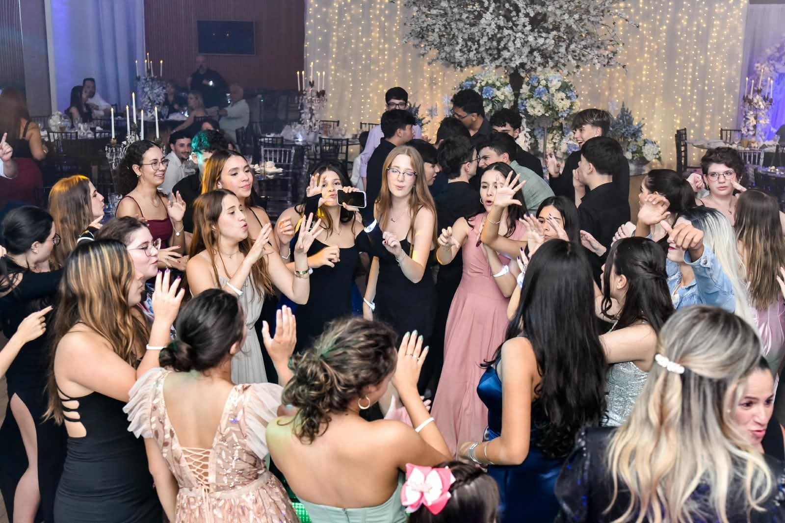 Pista de dança cheia com árvore de flores ao fundo