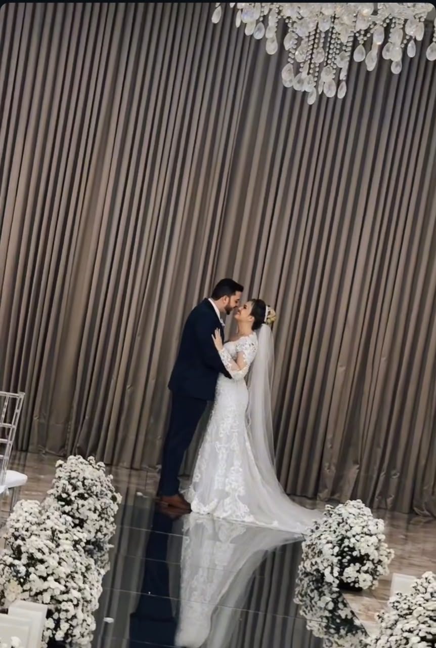 Noivos se beijando sob lustre de cristal